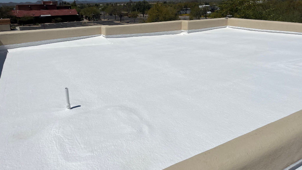 Flat foam roof and metal roofing on modern Arizona building